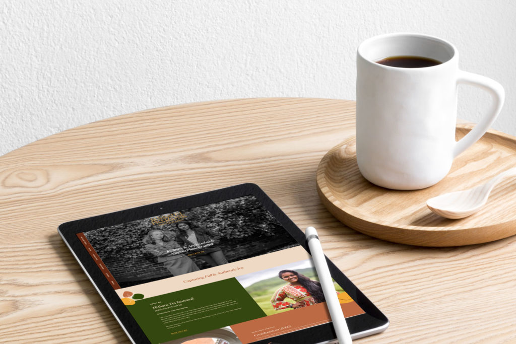 An ipad is laid on a table next to a cup of coffee.