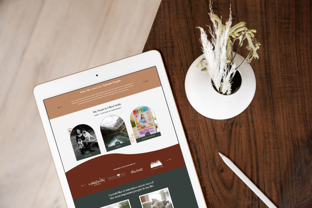 An ipad has a wavy photographer site next to a plant.