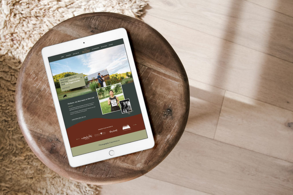 An ipad sits on a wooden stool with a green and red photography website pulled up.