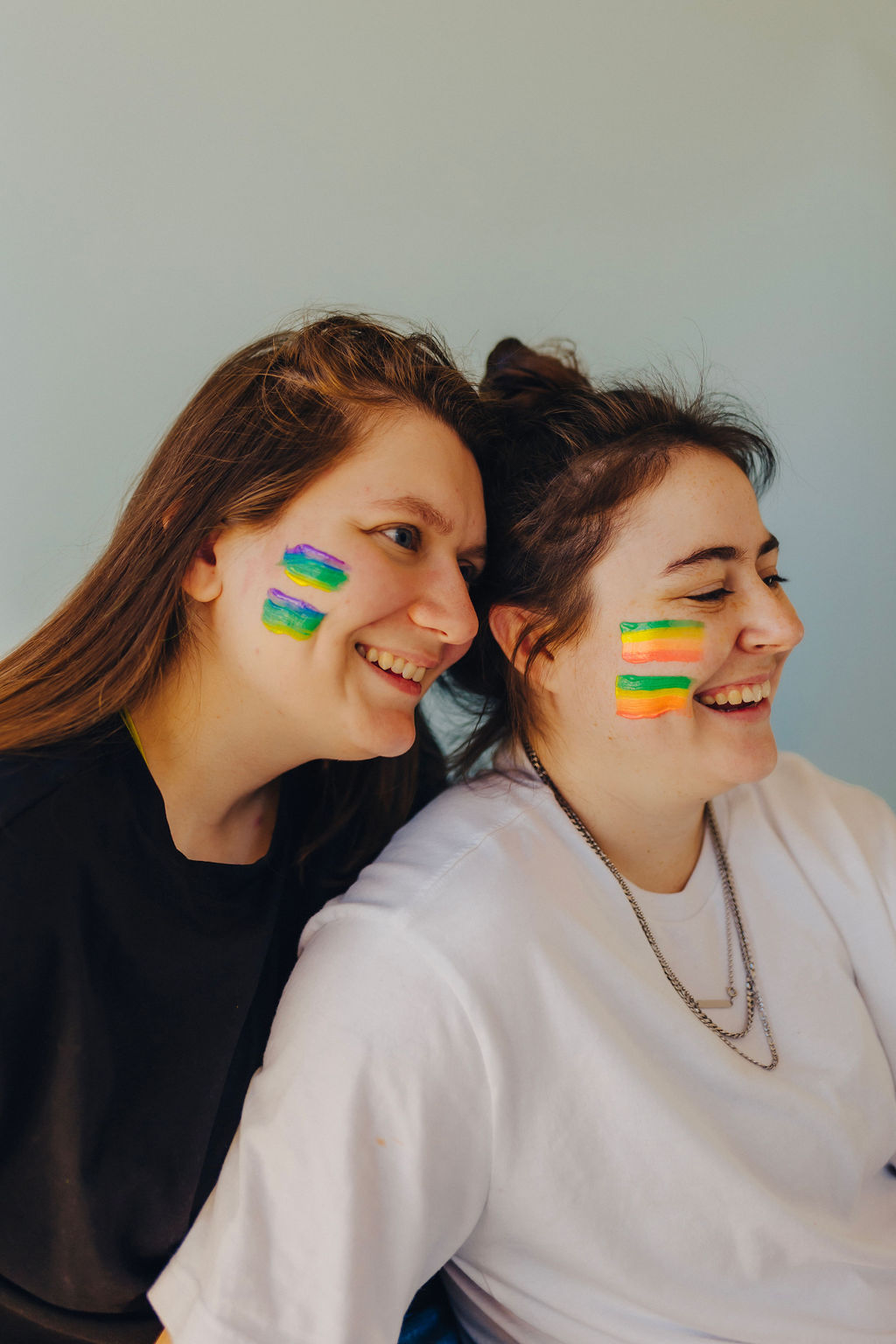 Two girls with paint on their face smile while thinking about boundaries in business.
