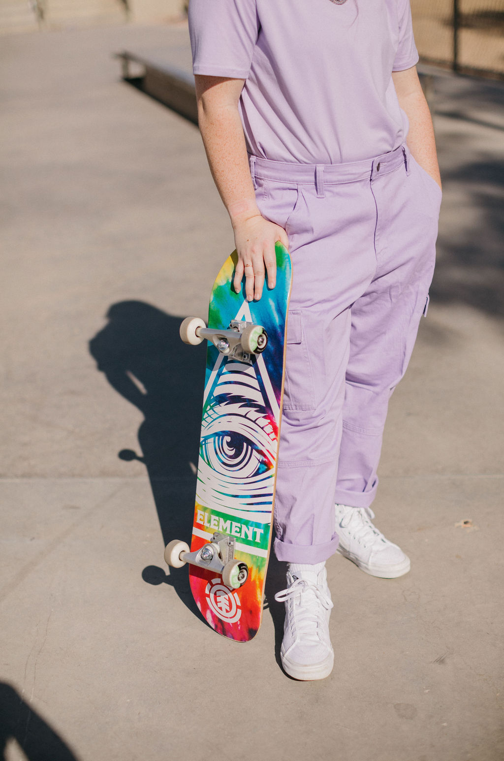 Girl in purple pants holding a skateboard wondering "is Yoast SEO good?"