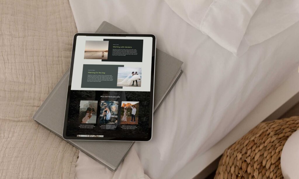 An ipad lays on a grey book on top of a bed with a photographer website pulled up on the screen.