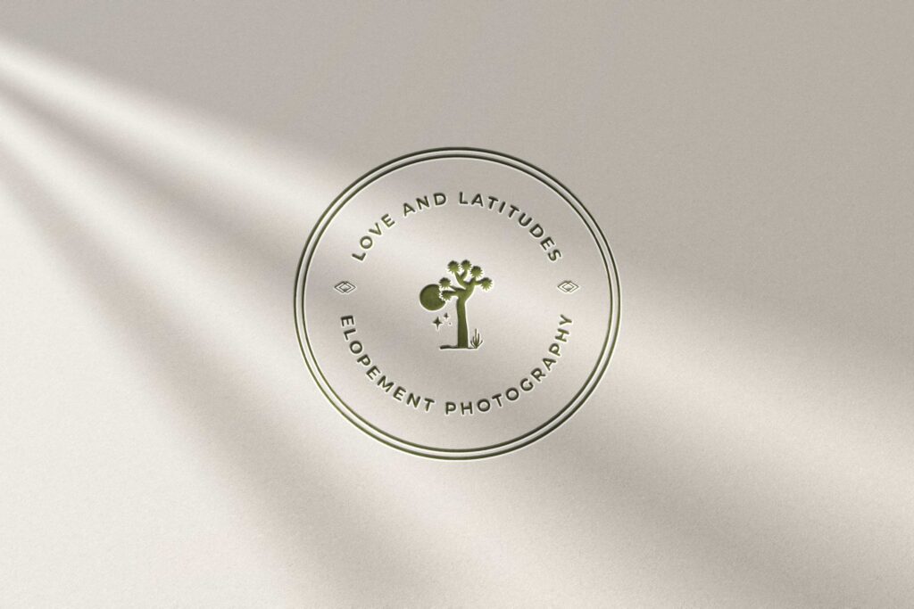 Elegant embossed logo of 'Love and Latitudes Elopement Photography' on a neutral background, showcasing brand identity in the design process