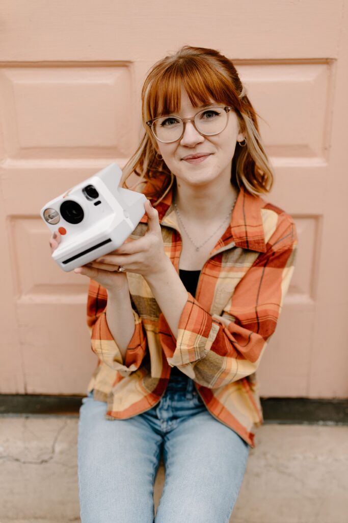 Tiffany poses with a camera.