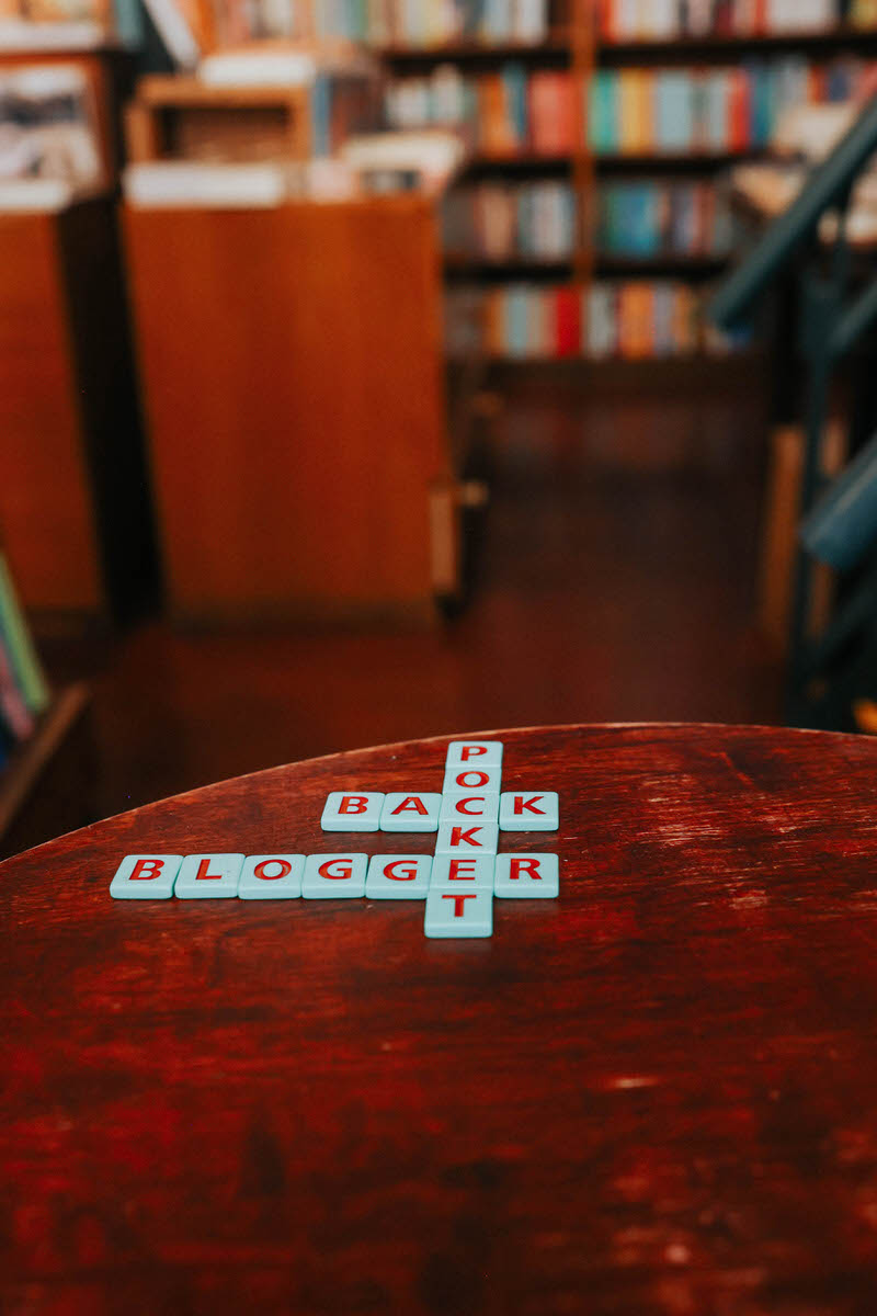 Scrabble pieces on a table spelling out back pocket blogger