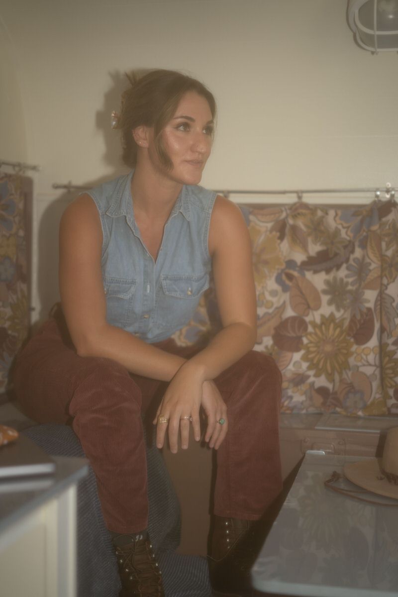 A vintage looking photo of a person sitting on a couch