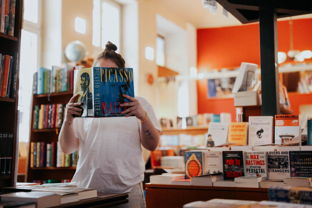 Jessie holds a picasso book up high.