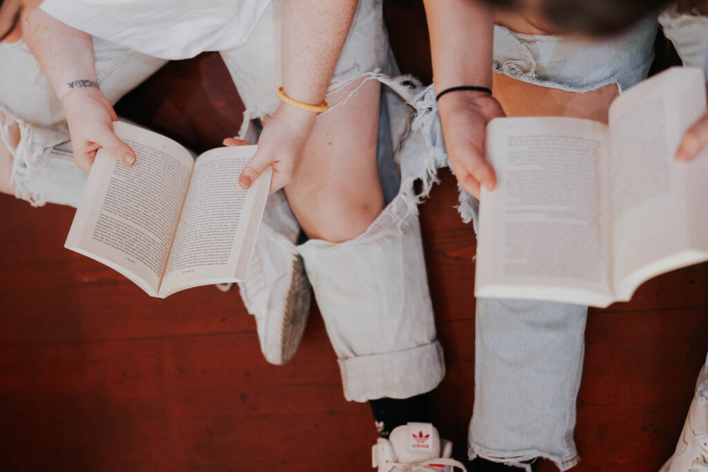 KP and Jessie sit with books open.