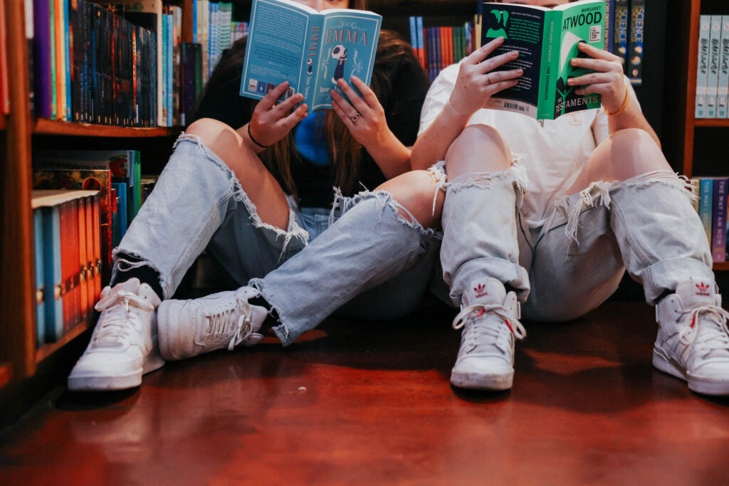 KP and Jessie read books on the floor.