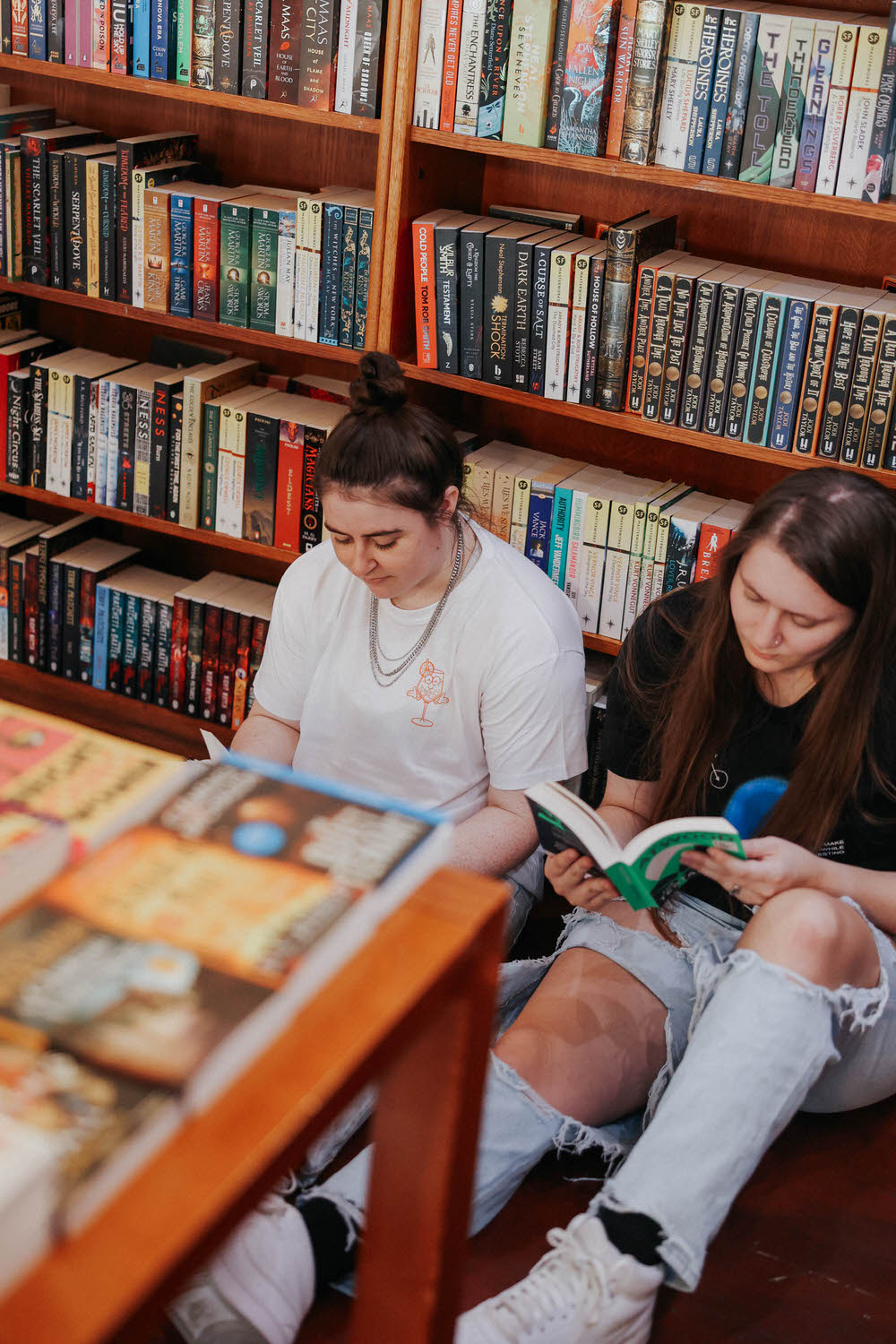 KP and Jessie read books in a bookstore.