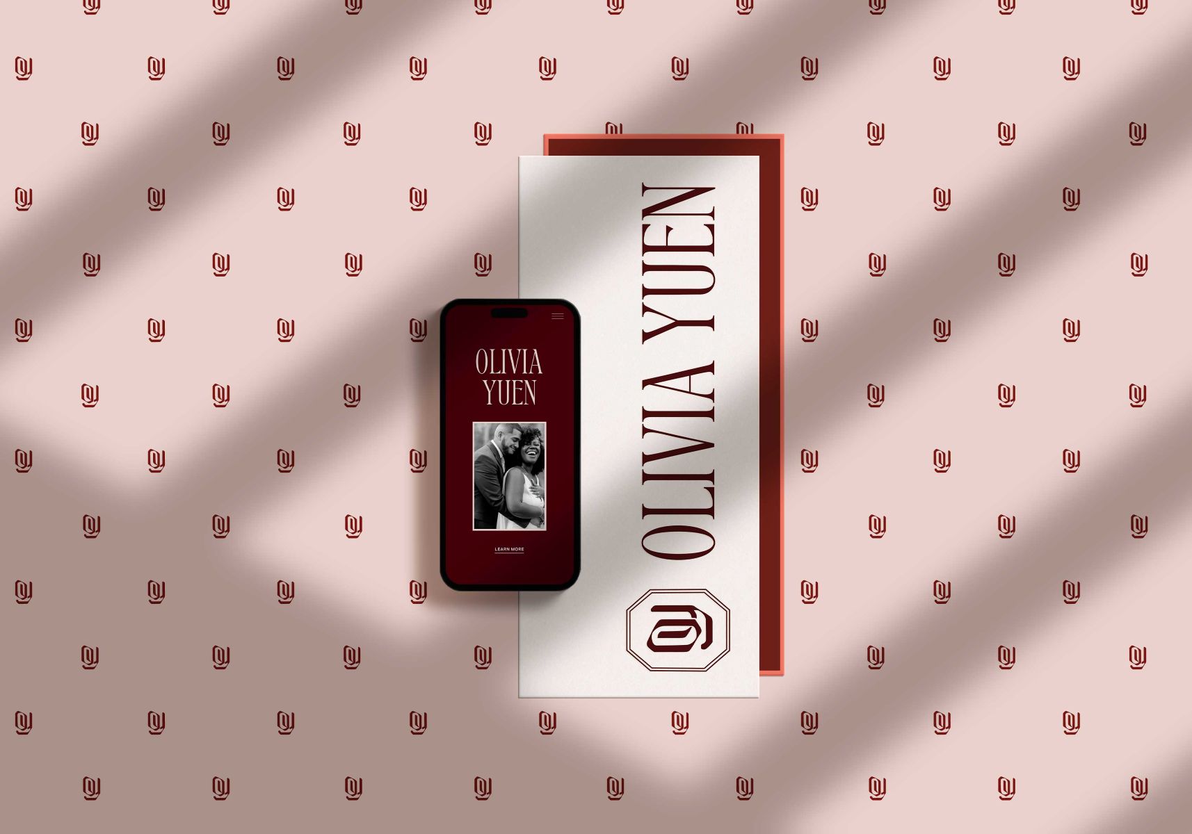 olivia yuen photography's website on a mobile phone with her branding elements next to the phone