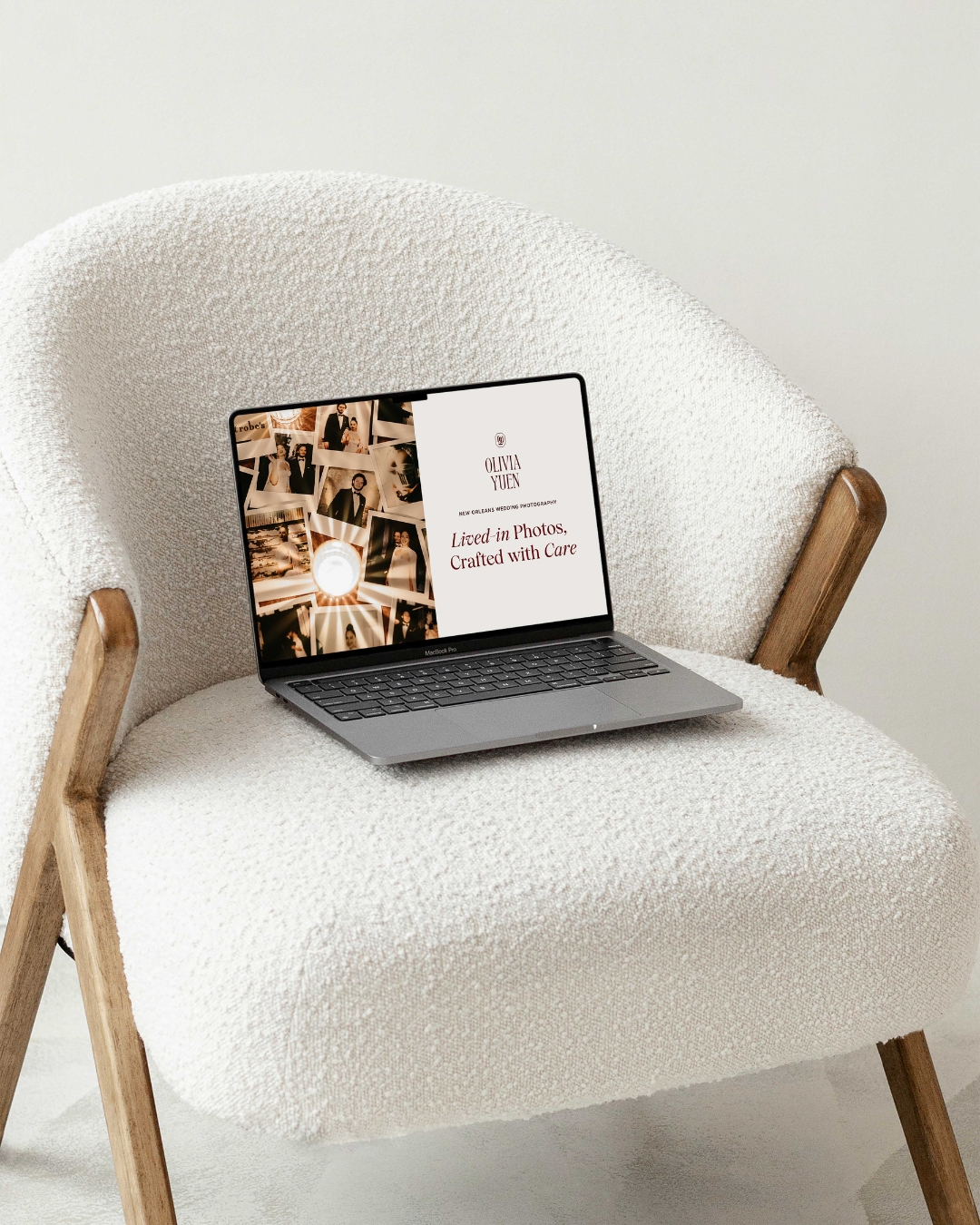 website page displayed on a laptop for olivia yuen photography on top of a white chair