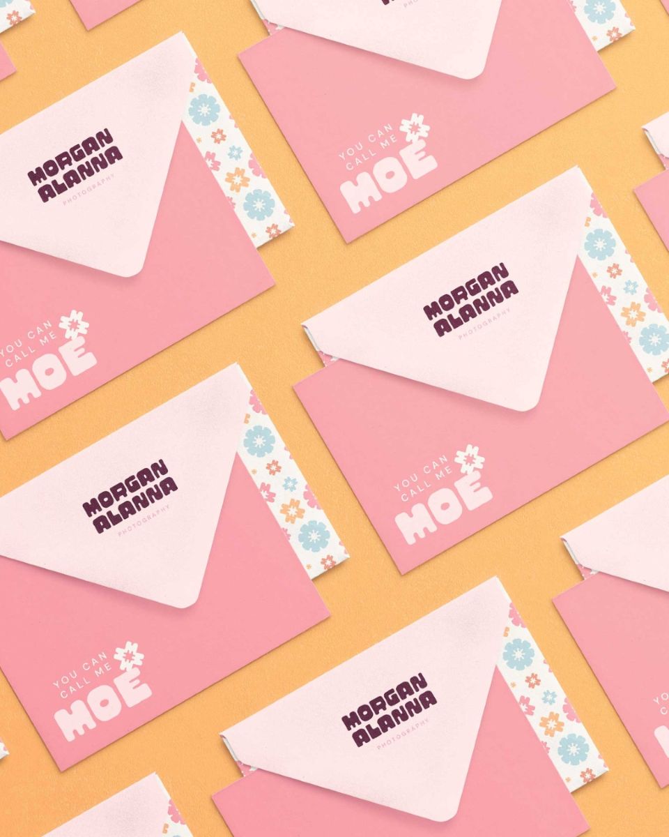 branded envelopes for morgan alanna photography set against a yellow backdrop