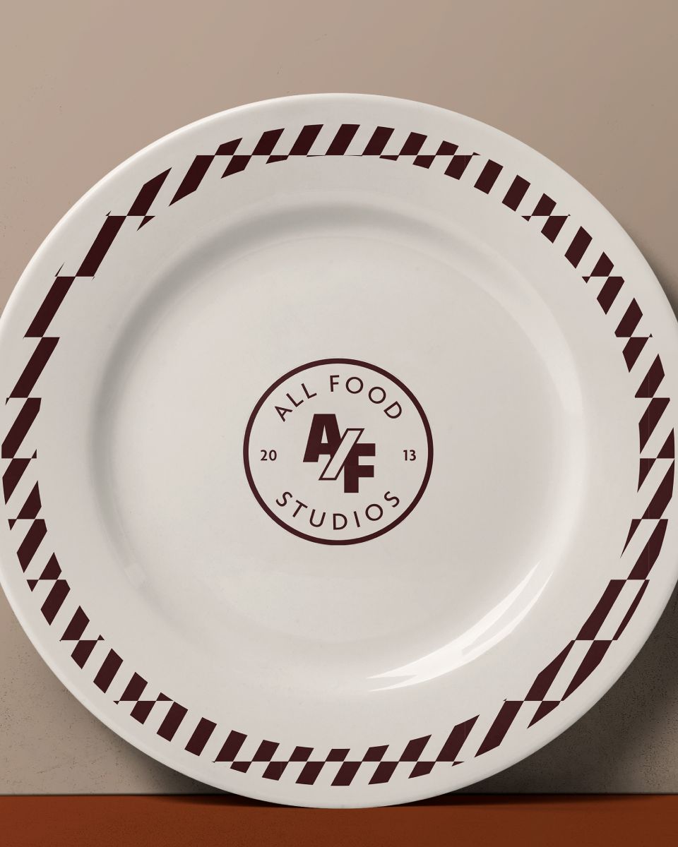 a white plate with the logo for all food studios