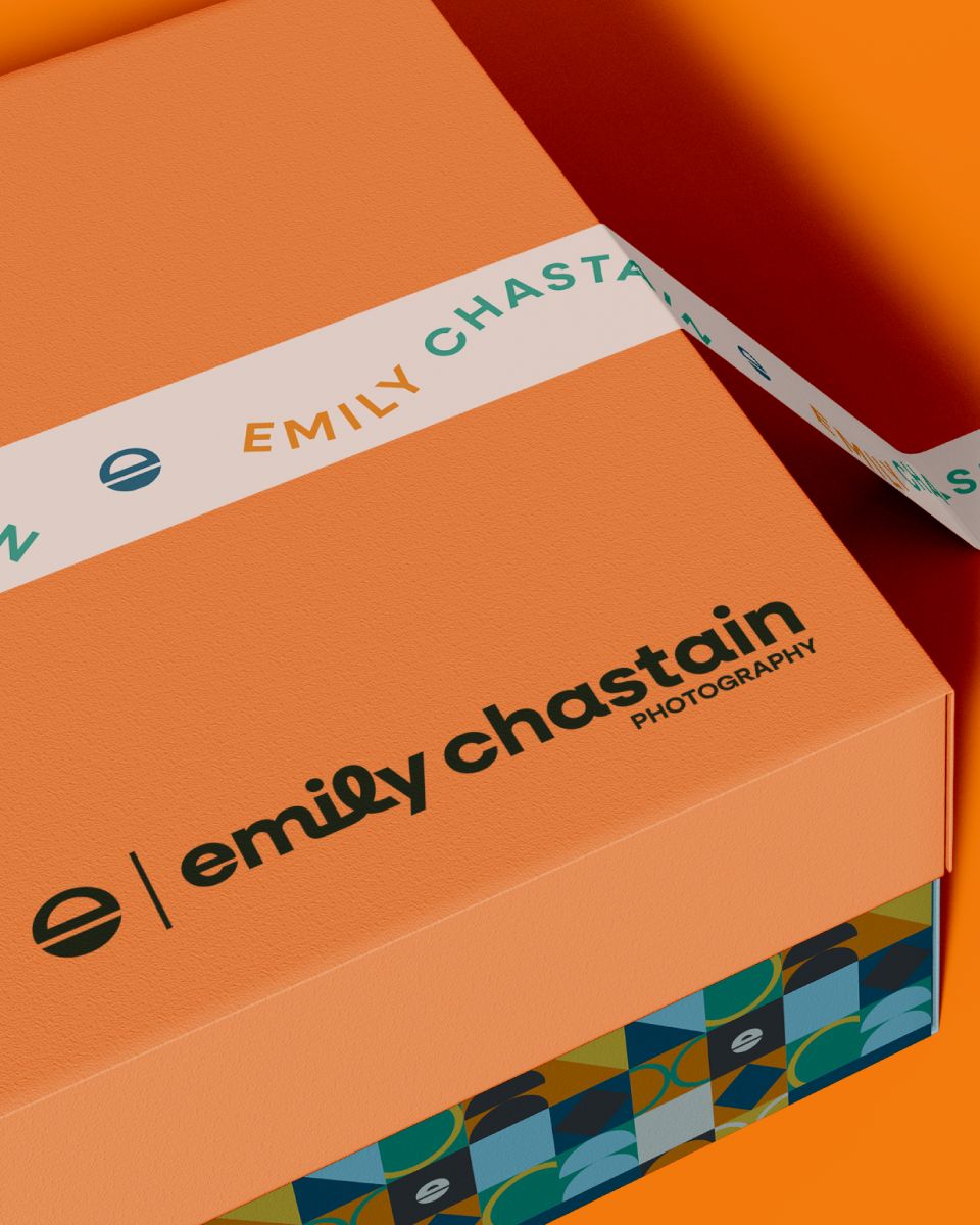 an orange box with the logo for emily chastain photography on top of it