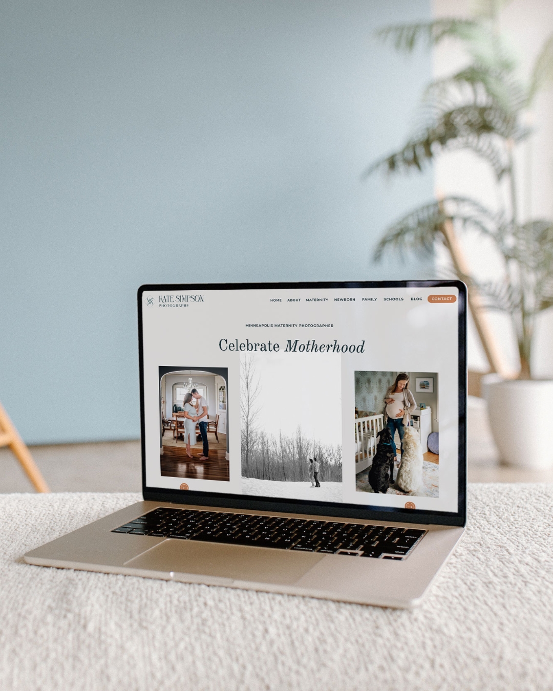website for kate simpson photography displayed on a laptop set on a couch
