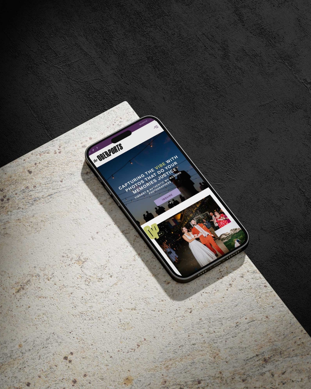 a mobile phone with a website for the oberports displayed resting on a marble table top 