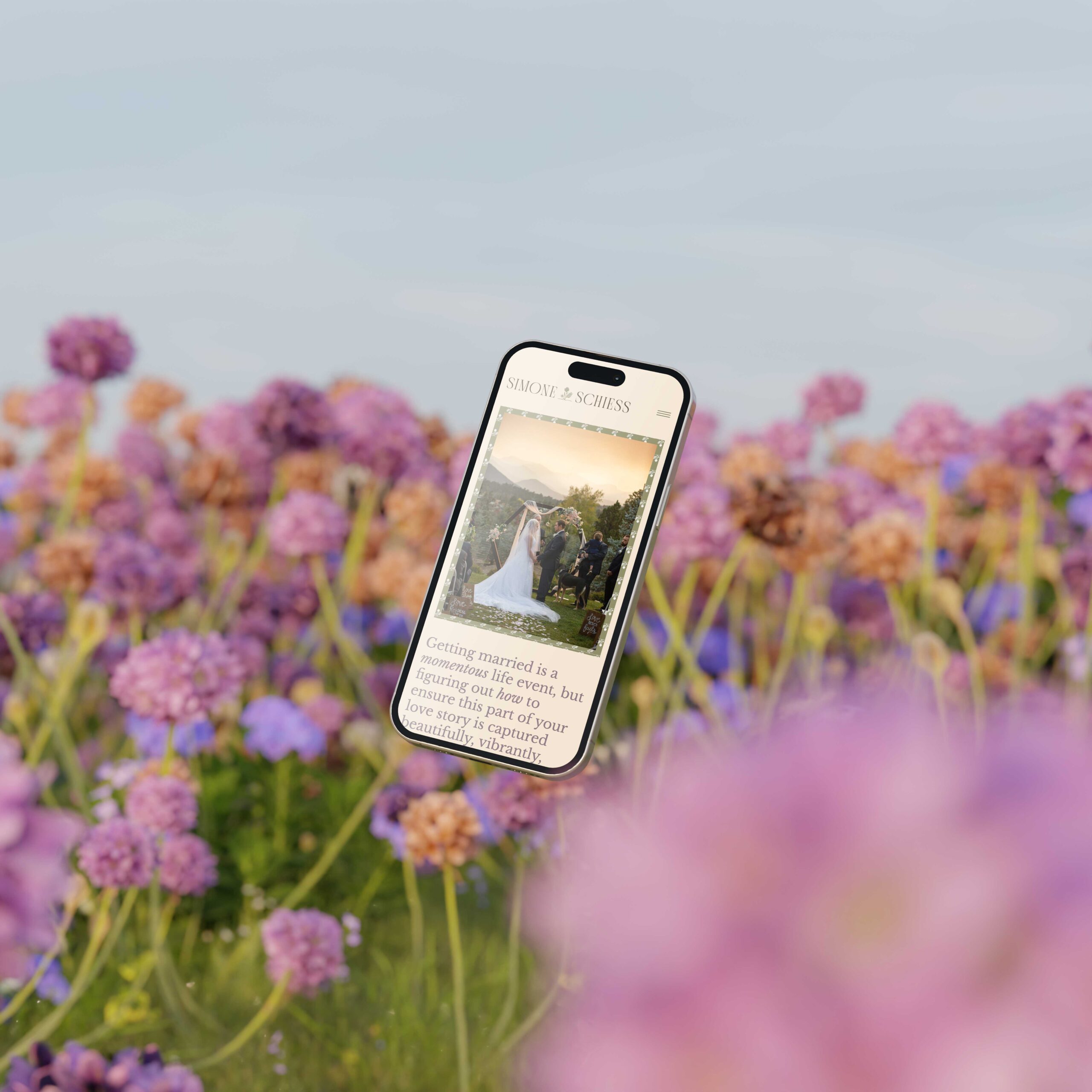 a phone with the website for simone schiess displayed set against a floral backdrop 