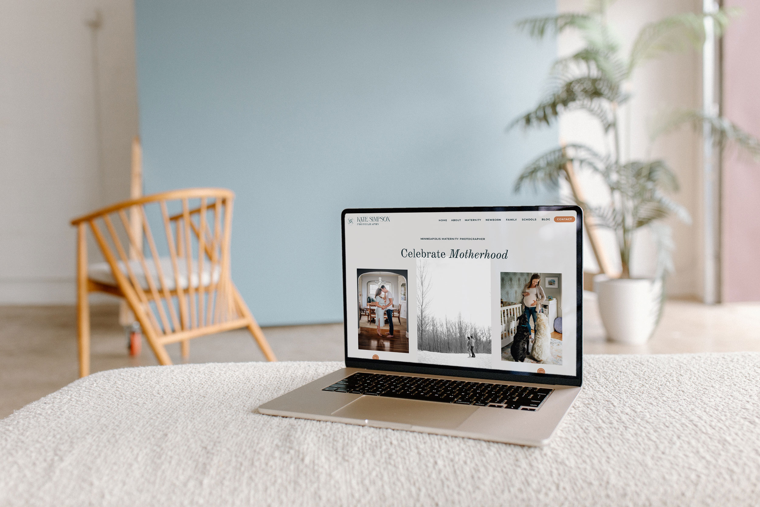 a laptop on a couch displaying the website for kate simpson photography 