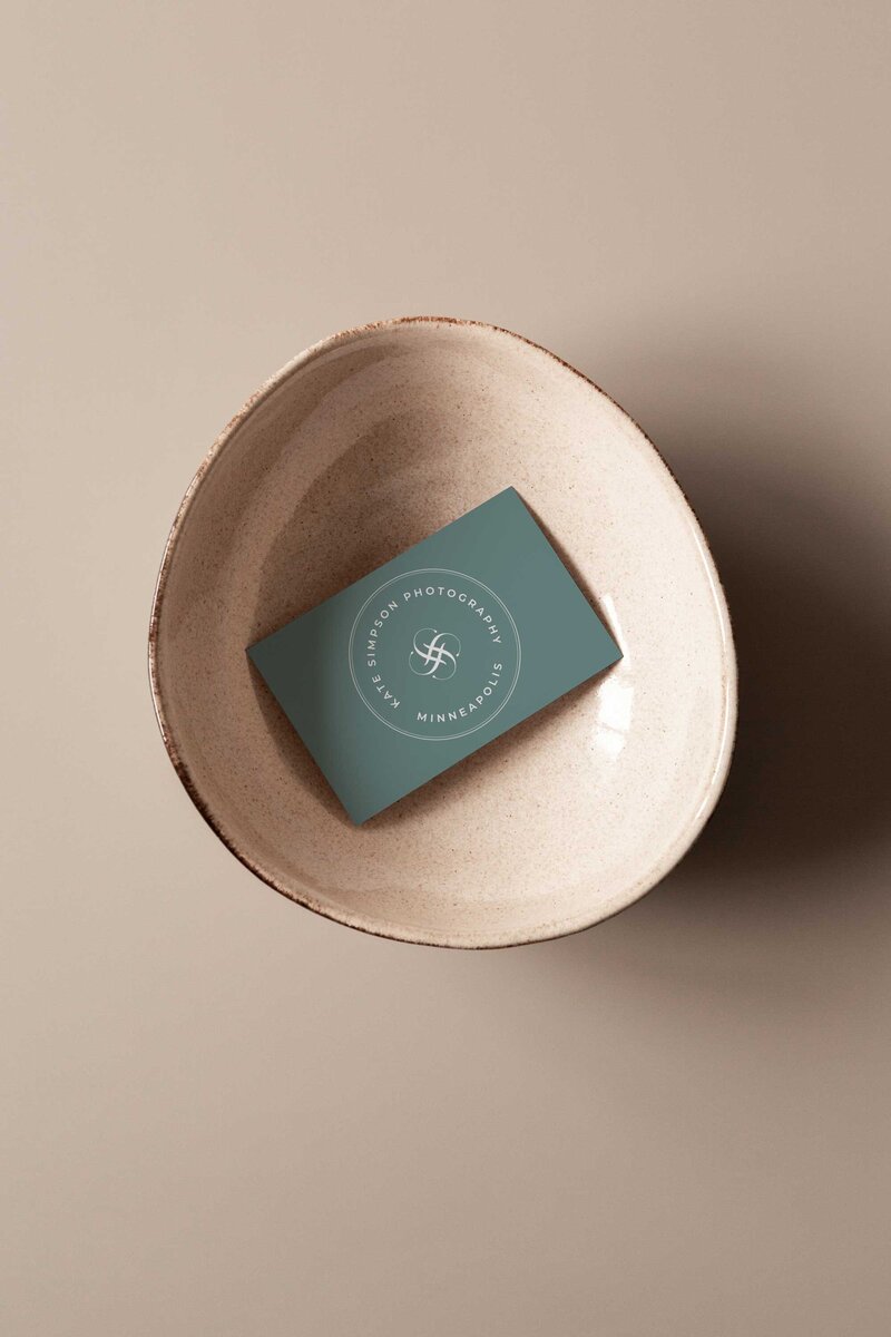 a business card in a bowl the business card is for kate simpson photography