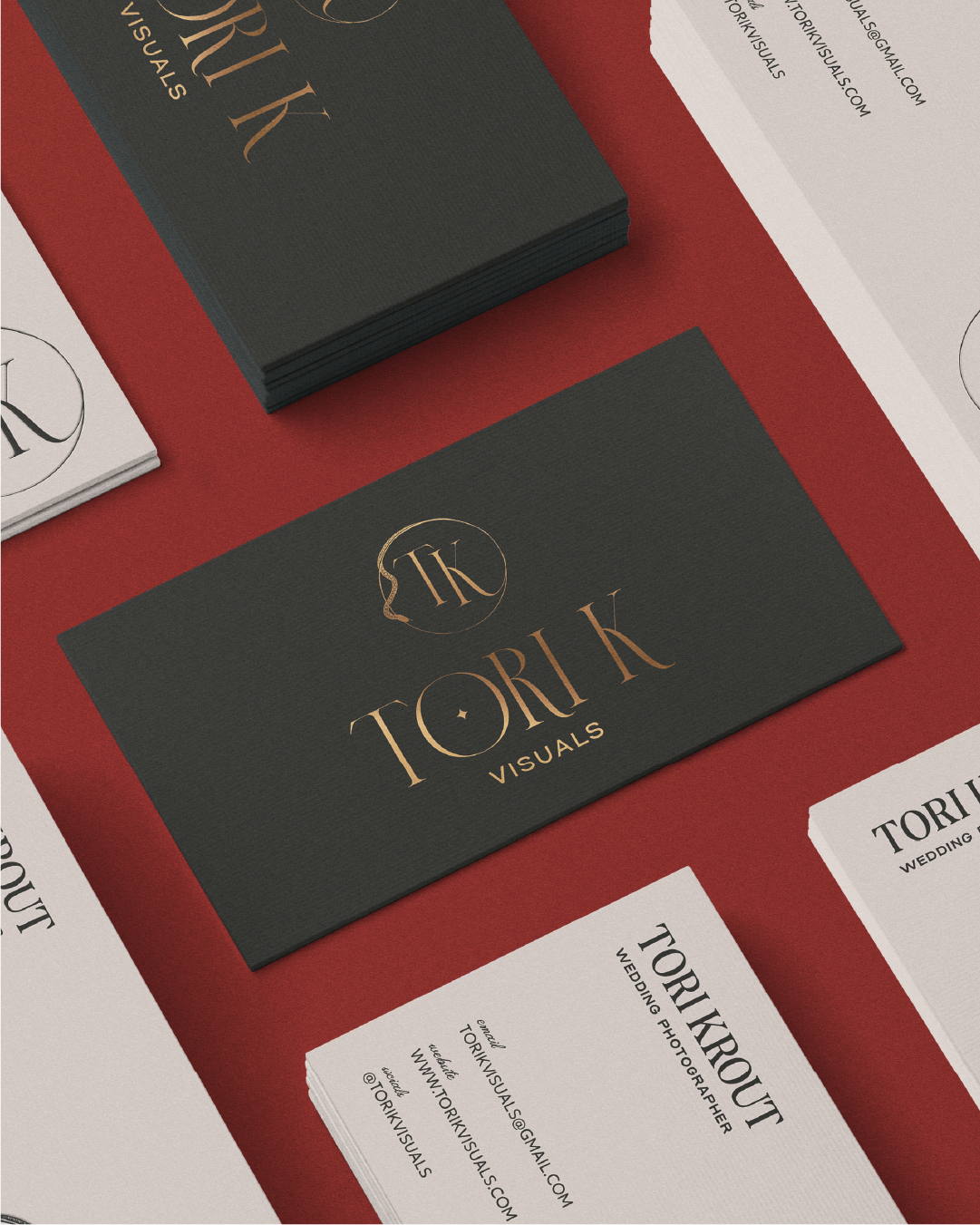 business cards with tori k visuals logo on it