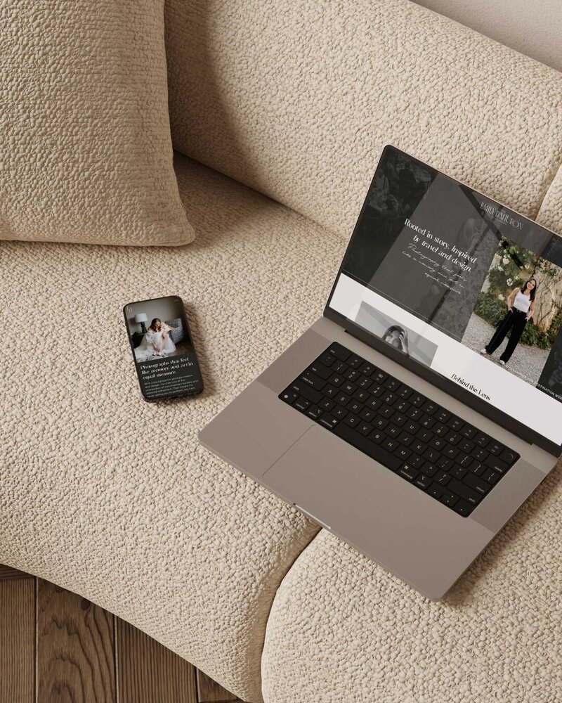 a laptop and mobile phone on a couch