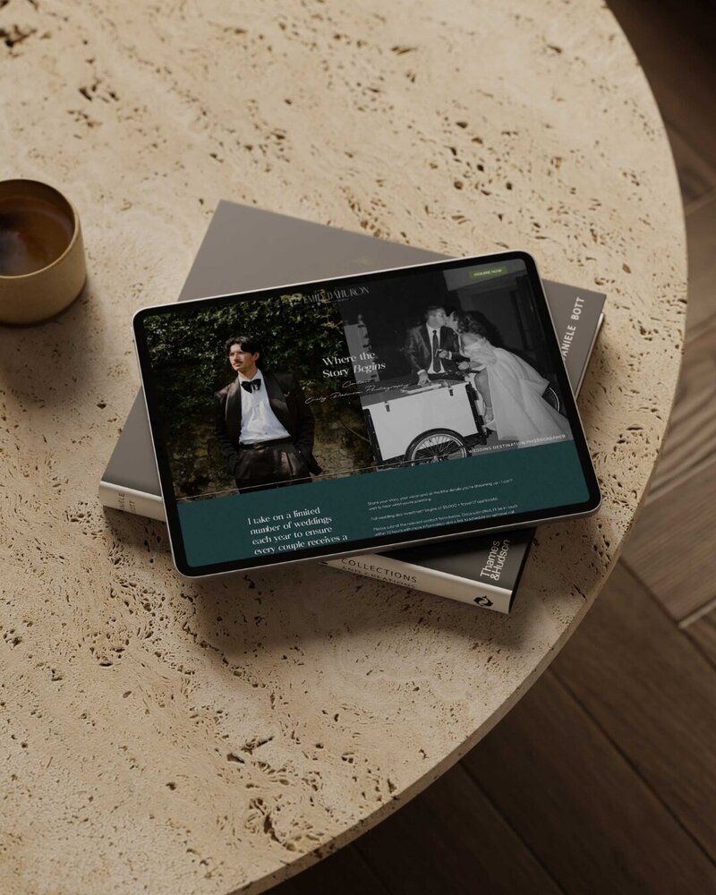 a tablet on top of a book on top of a marble table 