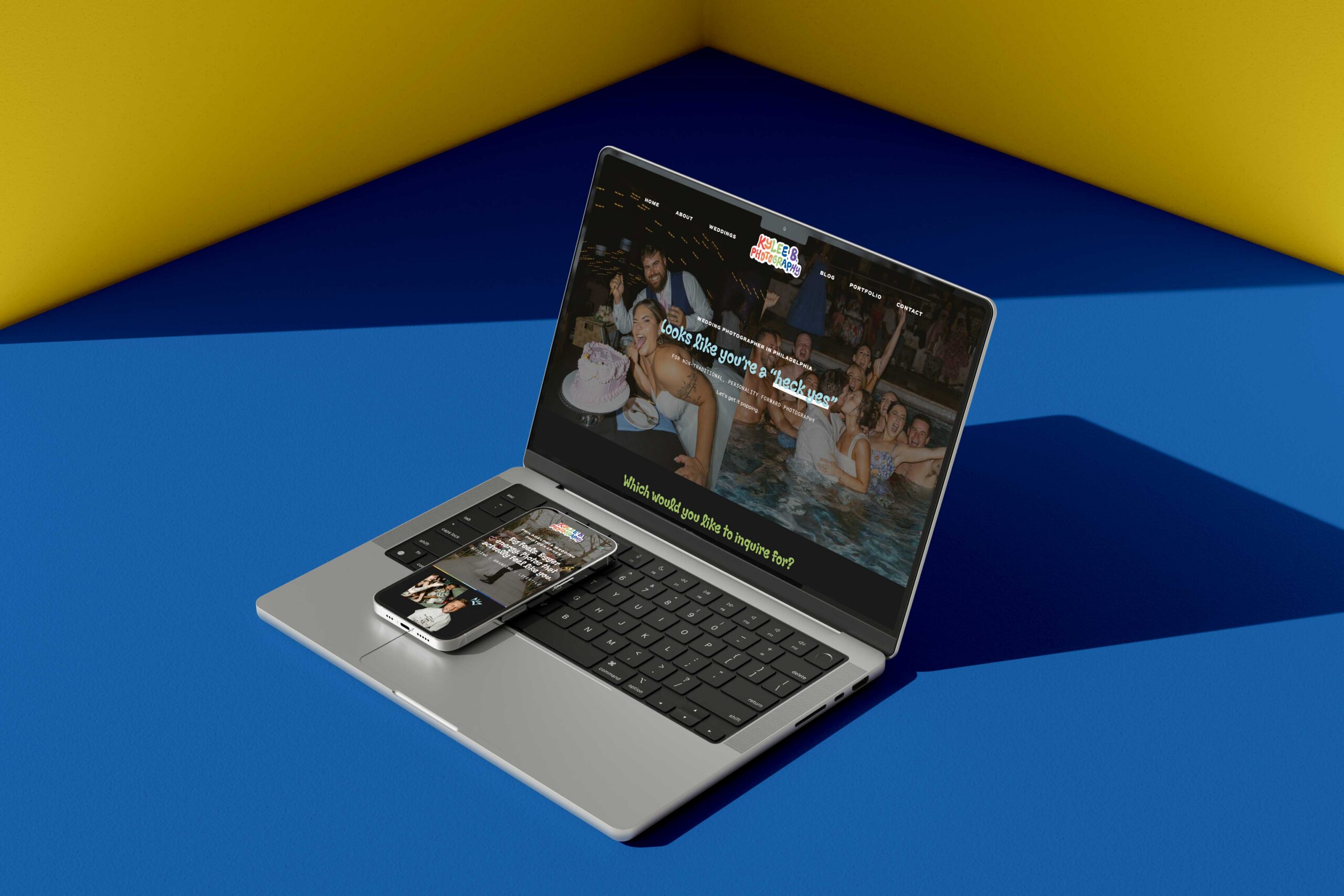 a laptop displaying the website of kylee b photography on top of the laptop is a mobile phone also displaying the website for kylee b photography