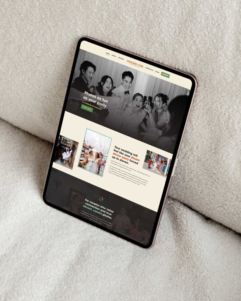 a tablet displaying the webiste for sarah bode clark photography the tablet is on top of a white couch