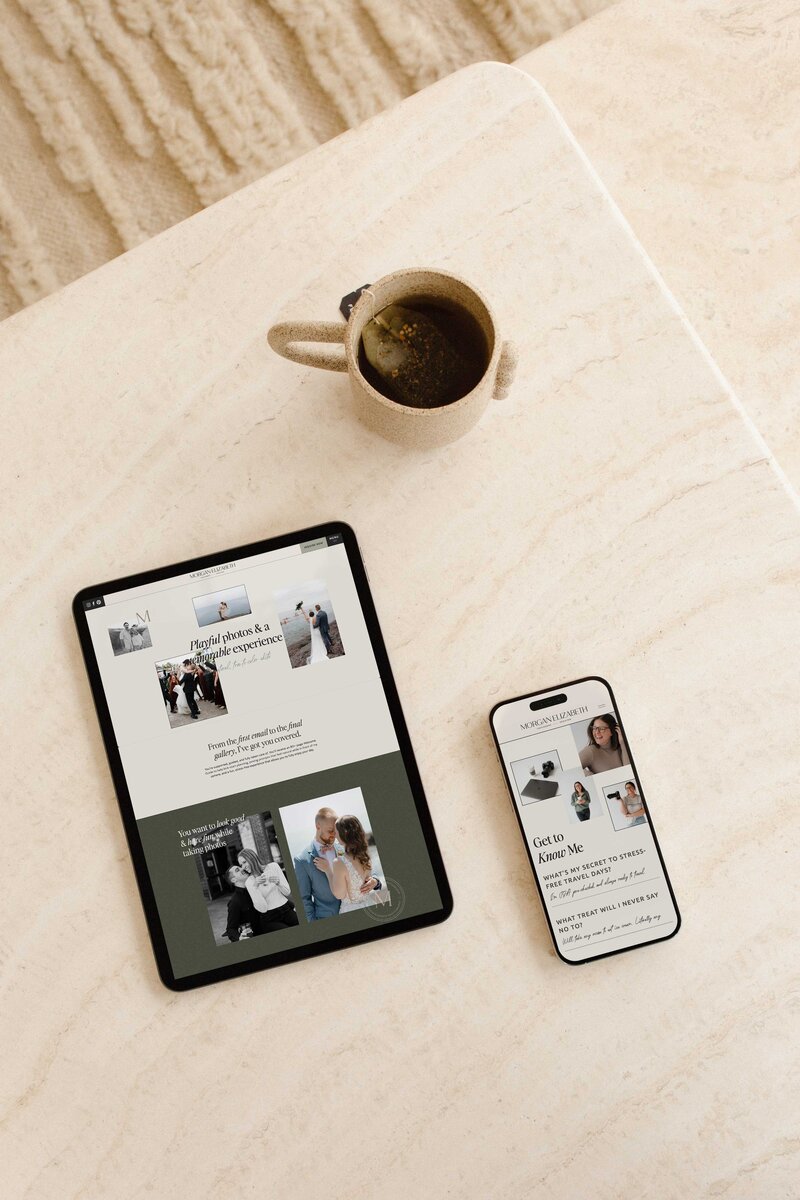 a tablet and phone on a table next to a cup of coffee the tablet and phone are displaying the website for morgan elizabeth photography
