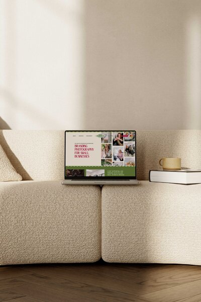 a laptop displaying the website for nikki robinson photography the laptop is on top of a couch 